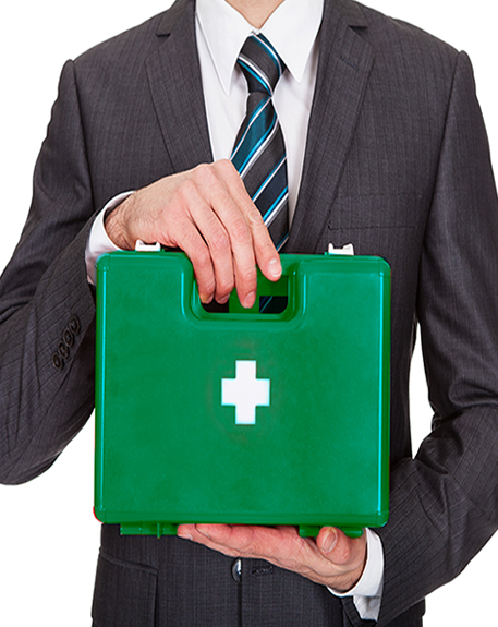 First Aid Training - Man in greay suit holding First Aid box